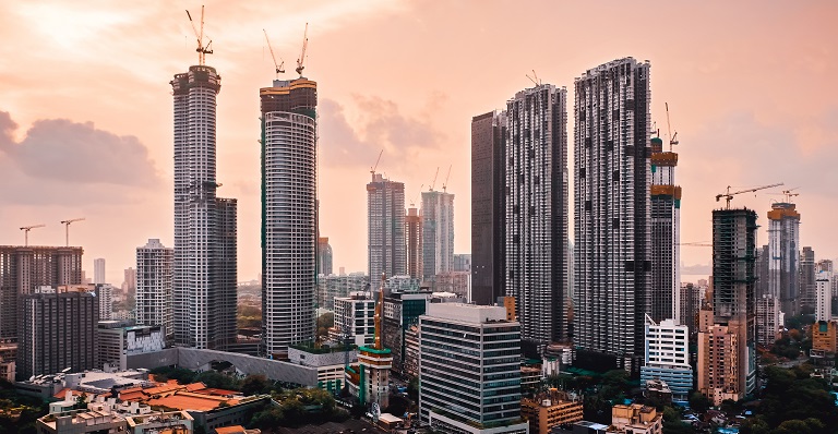 The skyline of Mumbai, India, at sunset. Many skyscrapers are under construction. 