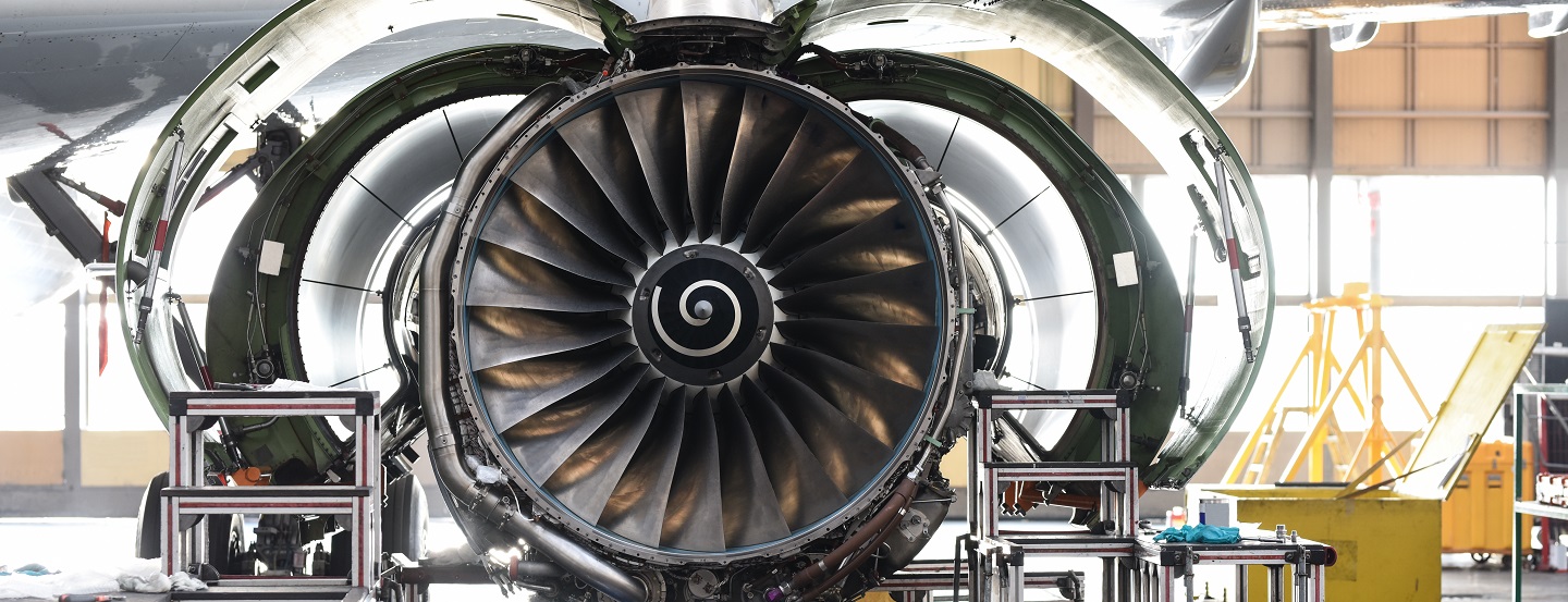 Aircraft jet engine maintenance in airport hangar