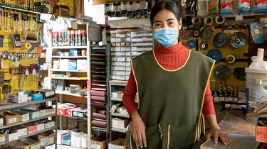 A woman stands in her store